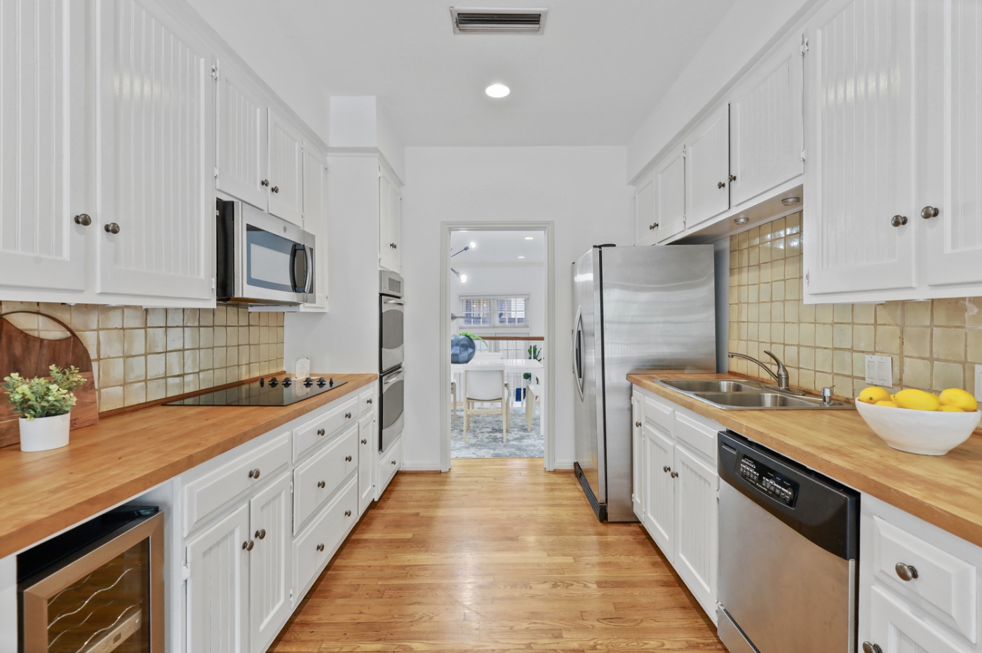 A narrow kitchen apartment, tastefully decorated with fruit bowls and wooden cutting boards