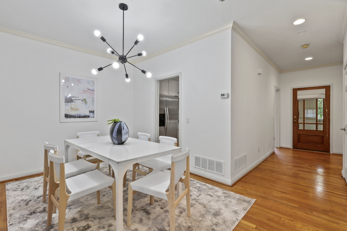 A dining room with white tabled and chairs