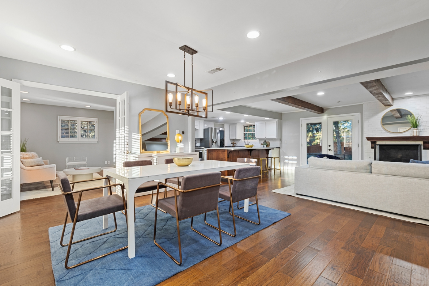An open concept living and dining room with a white dining room table